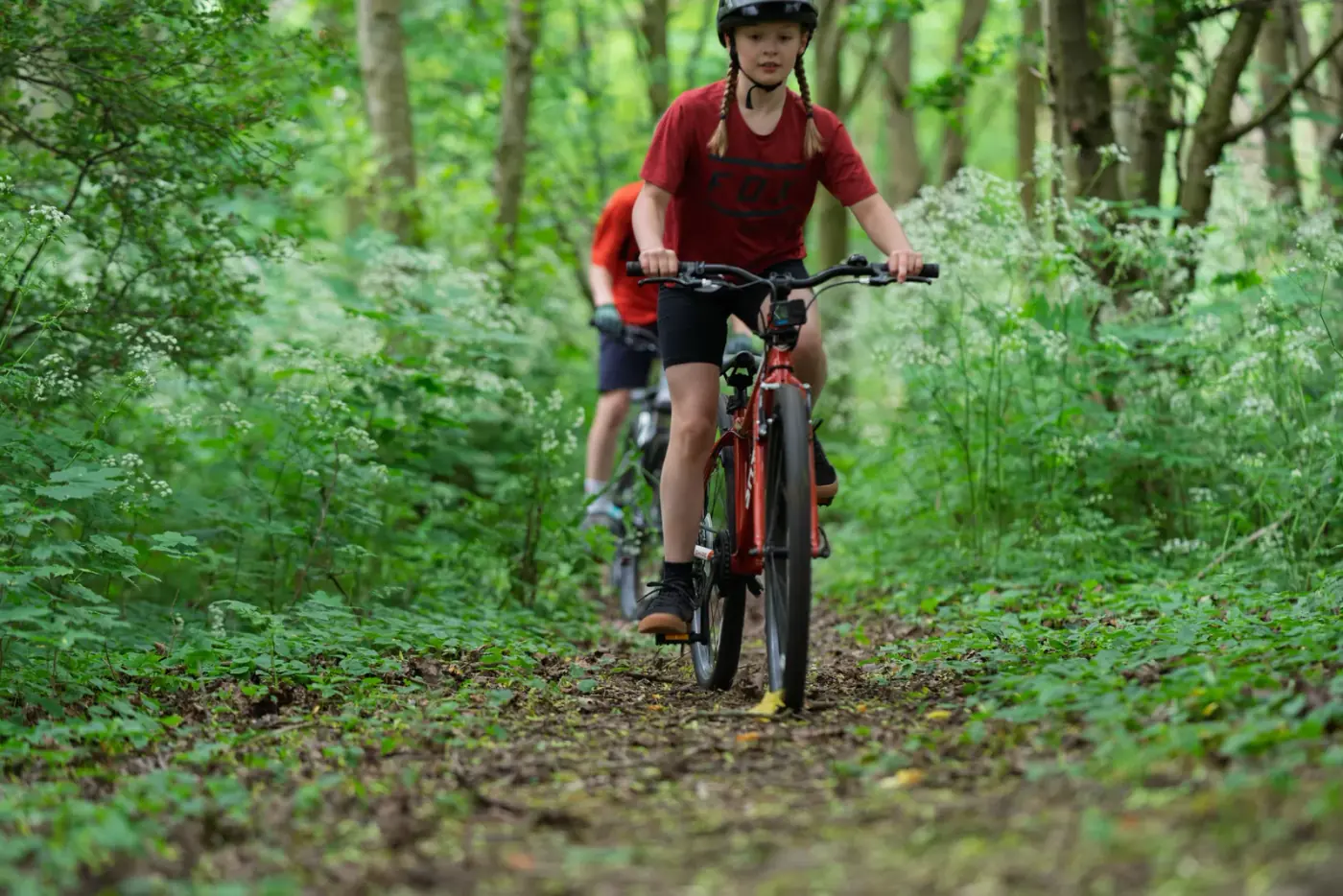 Two young riders on a Shyre on a woodland trail