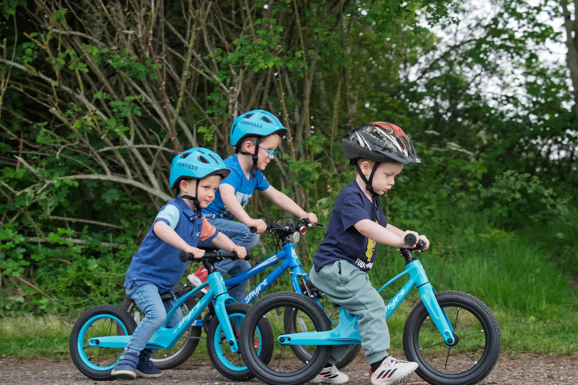 Three young riders on Shyre bikes, front on